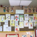 A notice board filled with pre-school children's artwork