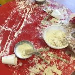 A pre-school child mixing flour and making dough