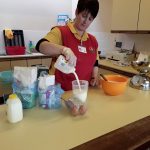 Harbour Bears' Pre-School leader demonstrating how to make Pancakes in Larne