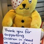 A Pudsey teddy bear holding a sign to say thank you for raising £70 for Children in Need