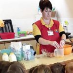 A Harbour Bears Pre-School leader demonstrating how to bake