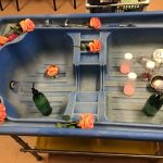 A water tray with roses, pumps and salts for children to create a Harbour Bears perfume