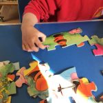 Child doing a jigsaw puzzle in pre-school