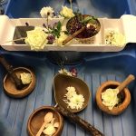Pre-school play with flowers and wooden bowls
