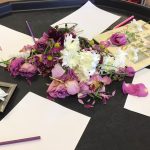 Art table setup with fresh flowers for pre-schoolers to draw