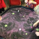 Pre-school children drawing in 'Space' themed table play