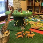 A jungle theme with play wild animals including lions, giraffes, and pandas