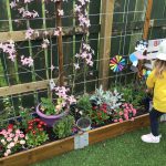 Playing in the garden with flowers and windmills