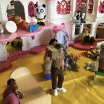 A doll house filled with different figurine characters