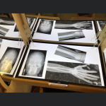 A mirrored desk with images of X-Rayed human bones