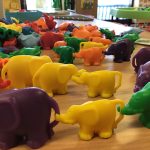 A trails of play elephants linked together