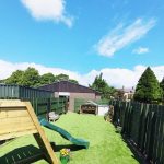 A view of the garden at Harbour Bears in the summer featuring a slide